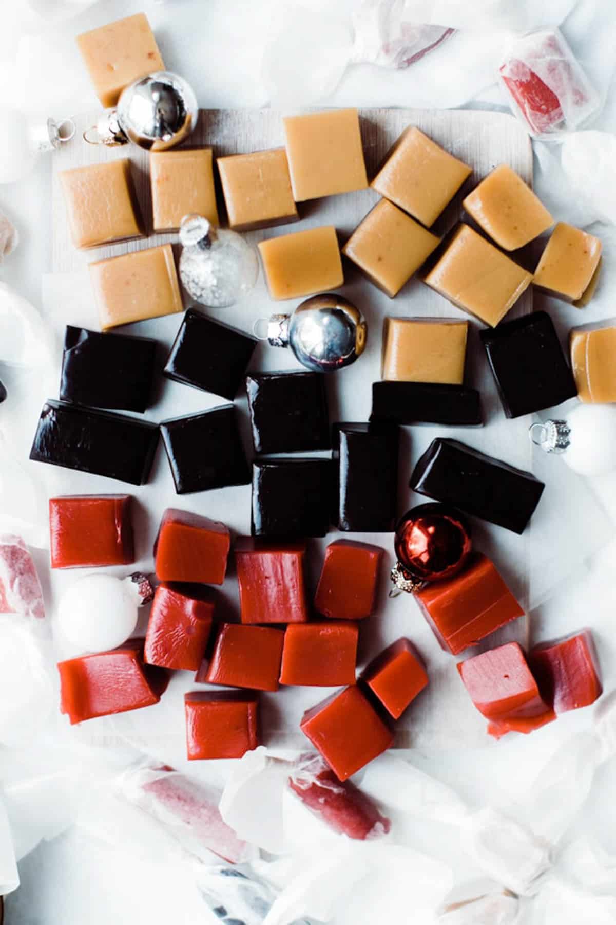 Different varieties of sea salt caramels along with black and red square of caramels.