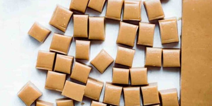 Sea salt caramels on white background cut into pieces.