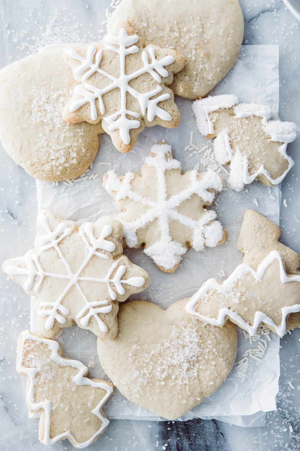 Winter themed sugar cookies with white frosting and chunky sprinkle sugar. 