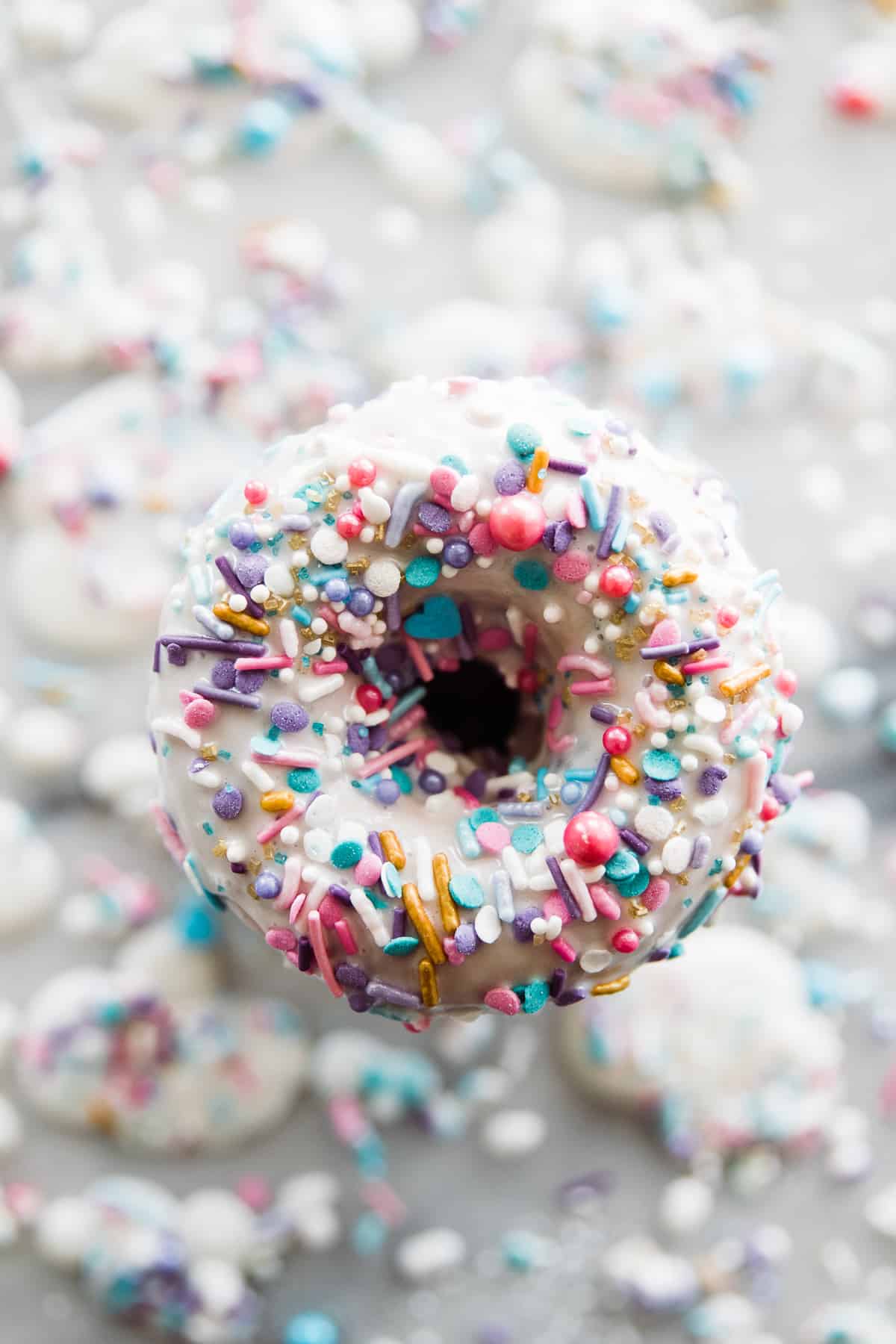 One frosted baked donut with sprinkles