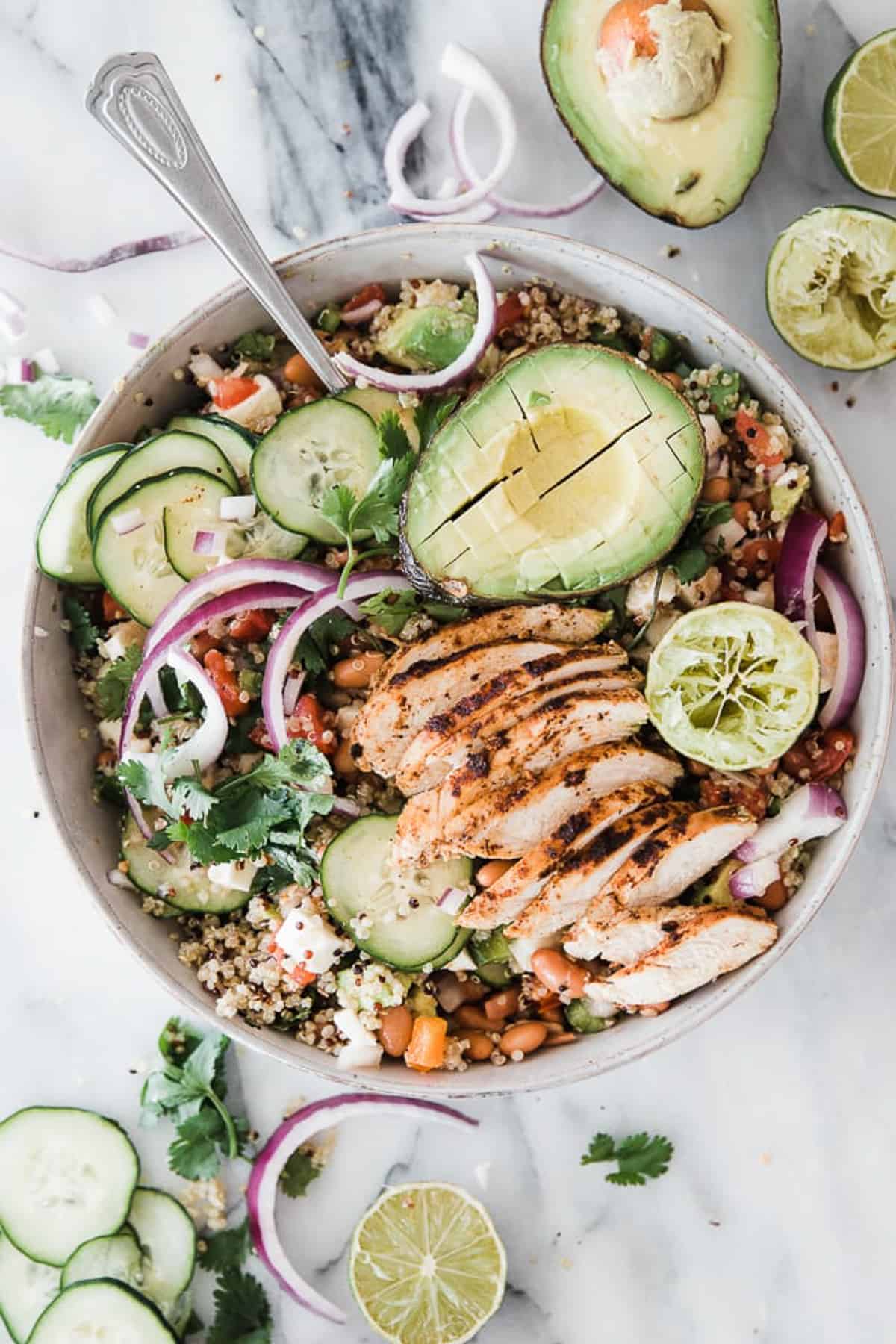 bowl of chicken, veggies, quinoa and avocado. 
