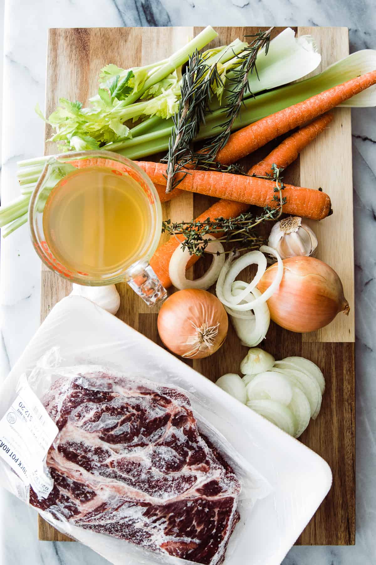 Ingredients to make instant pot frozen roast beef on a cutting board.