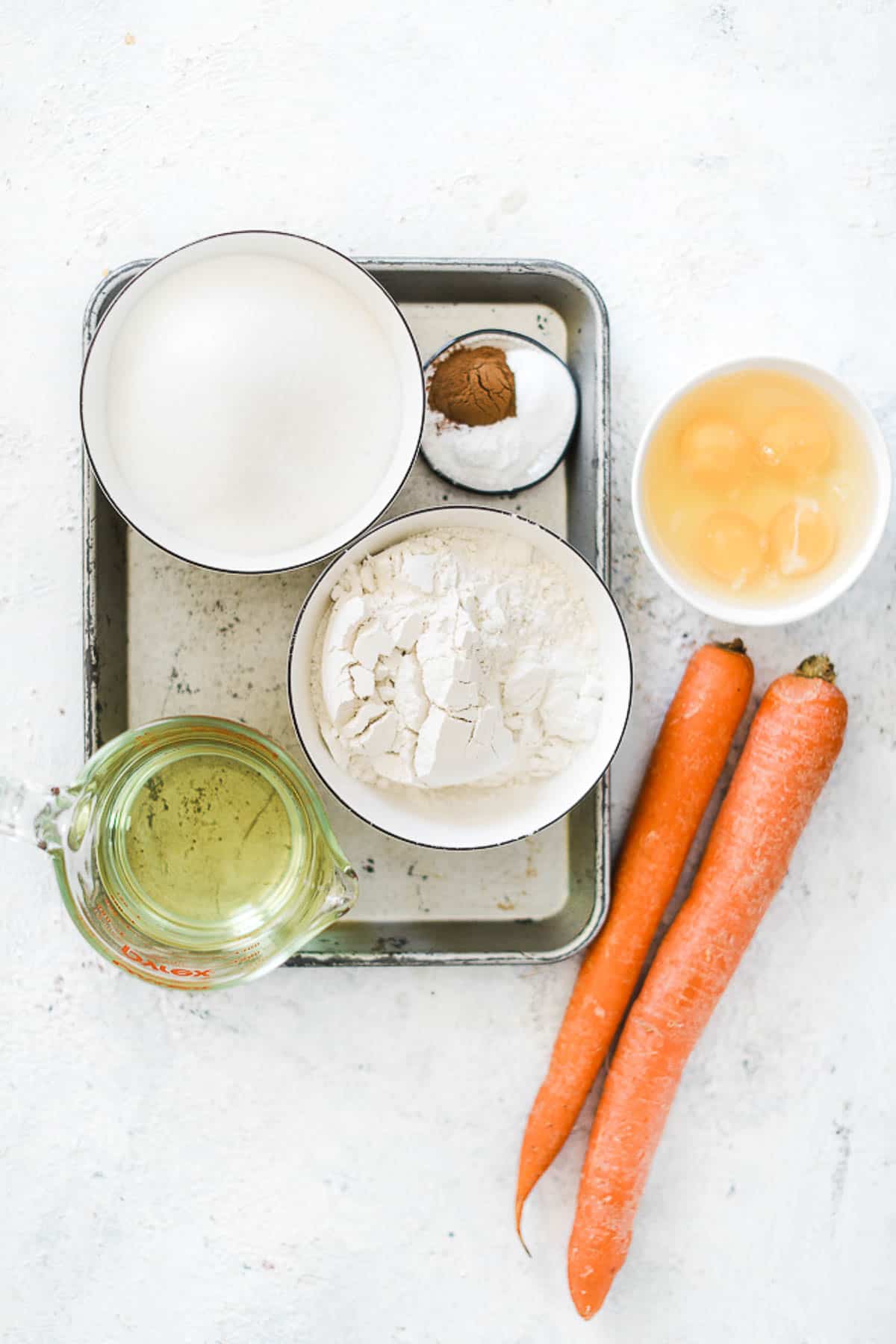 Ingredients needed to make carrot cake.