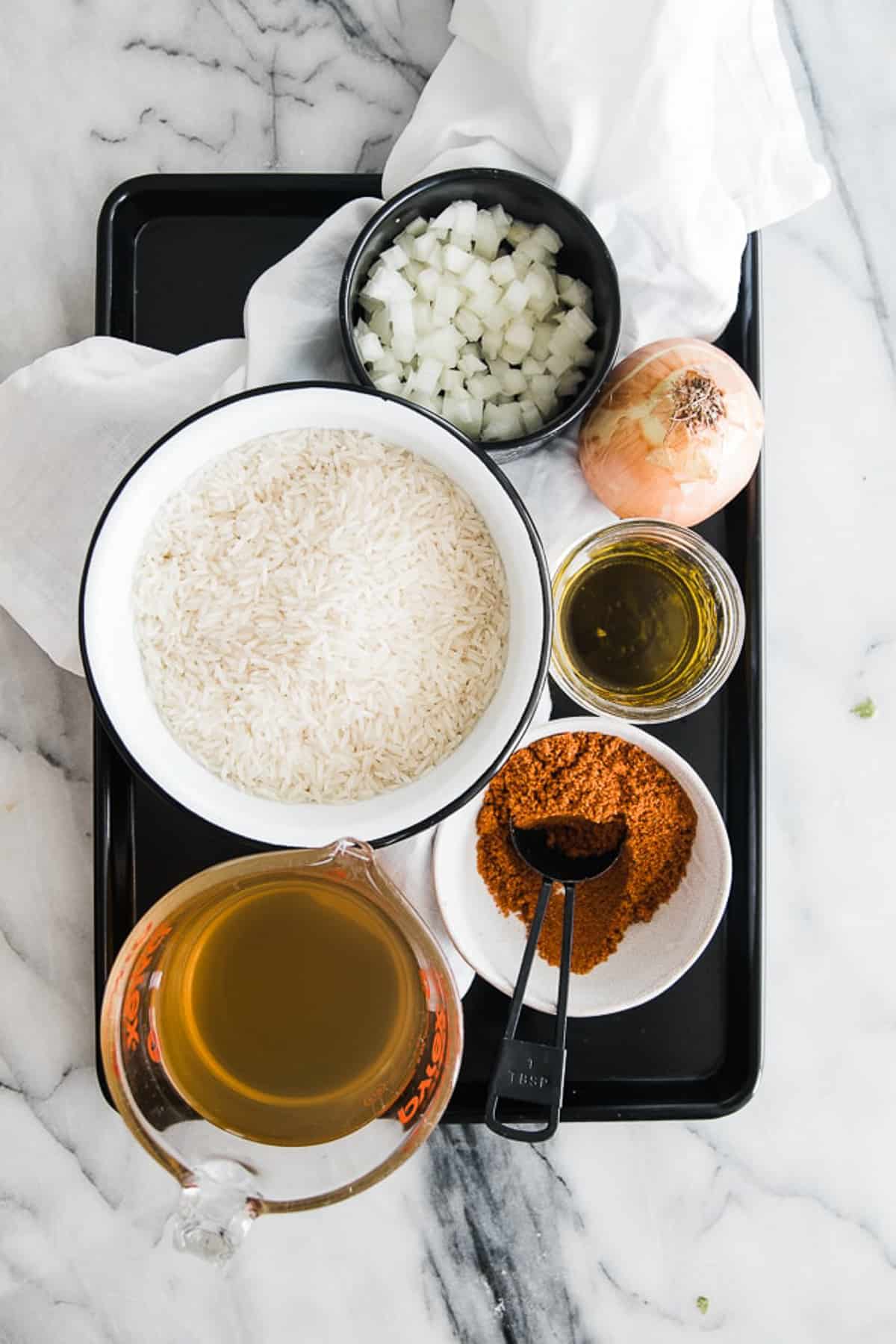 ingredients of instant pot Mexican rice on a baking tray

