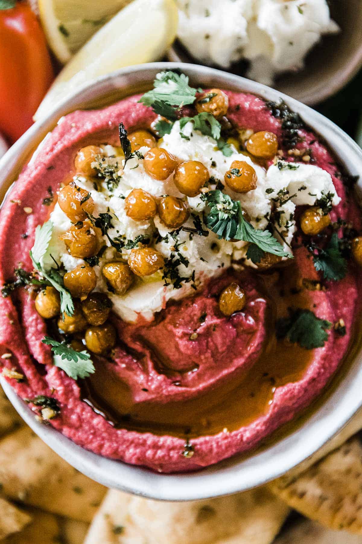 Beet hummus garnished with roasted chick peas and goat cheese.