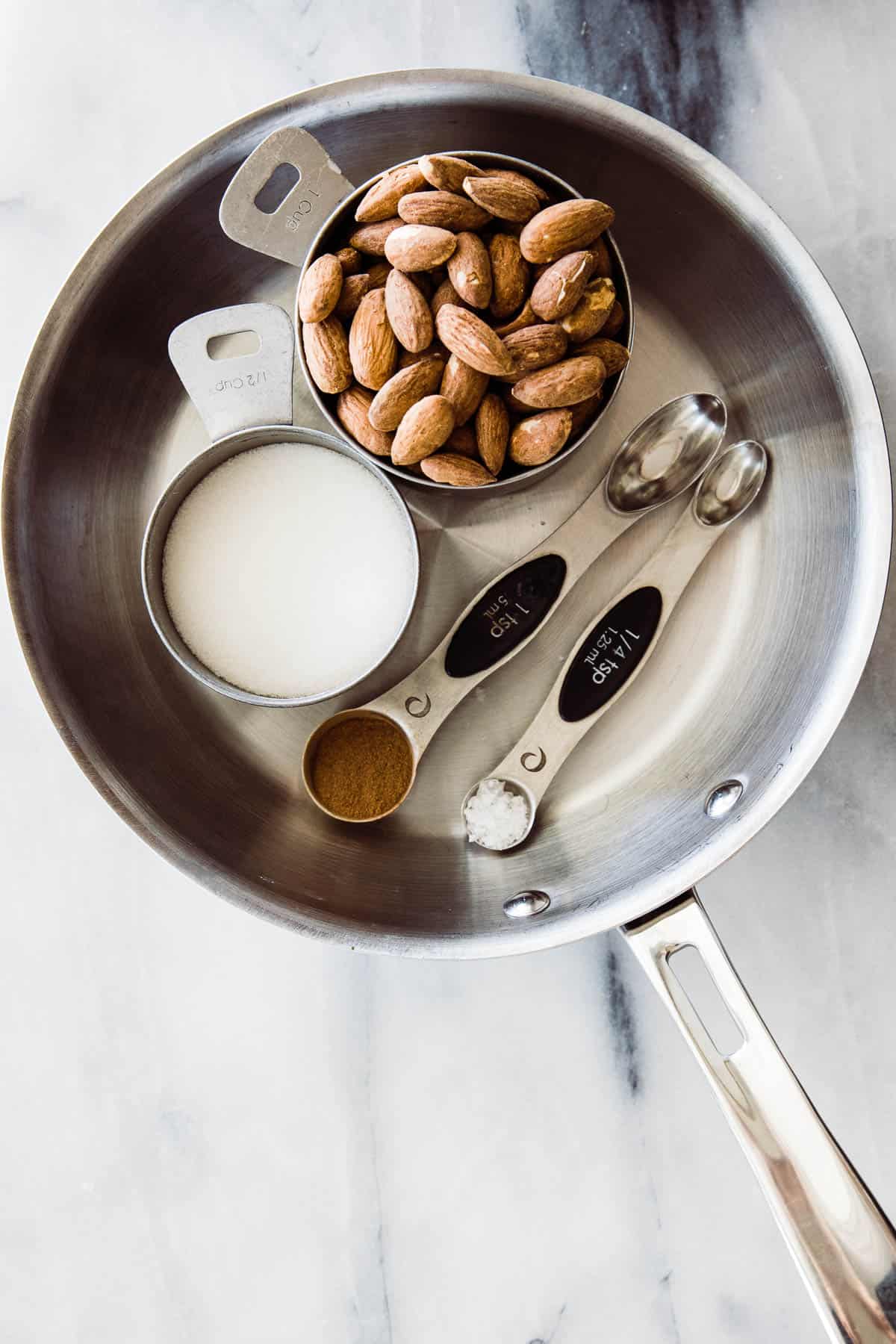ingredients of almonds, sugar, cinnamon in small skillet. 