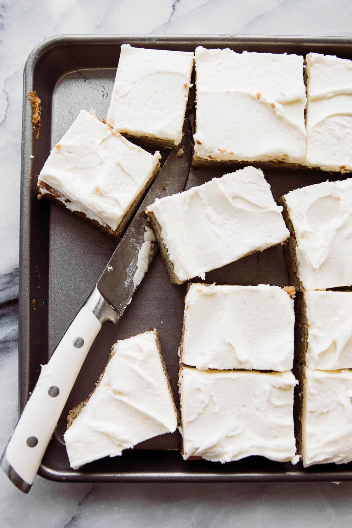 Frosted banana bars cut into squares. 