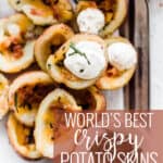 Pin for pinterest graphic with image of crispy baked potato skins on a table with text on top.