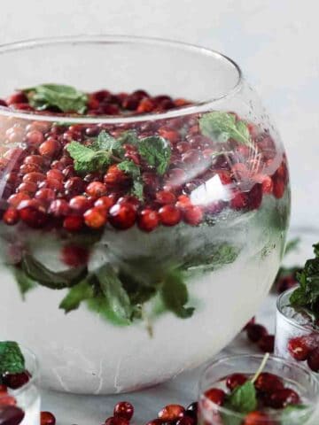 Cranberry mint water in a glass punch bowl.