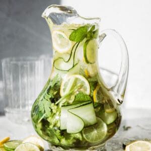 Pitcher full of cucumber, lemons and herbs.