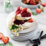 Easy strawberry shortcake on a grey plate garnished with chamomile flowers.