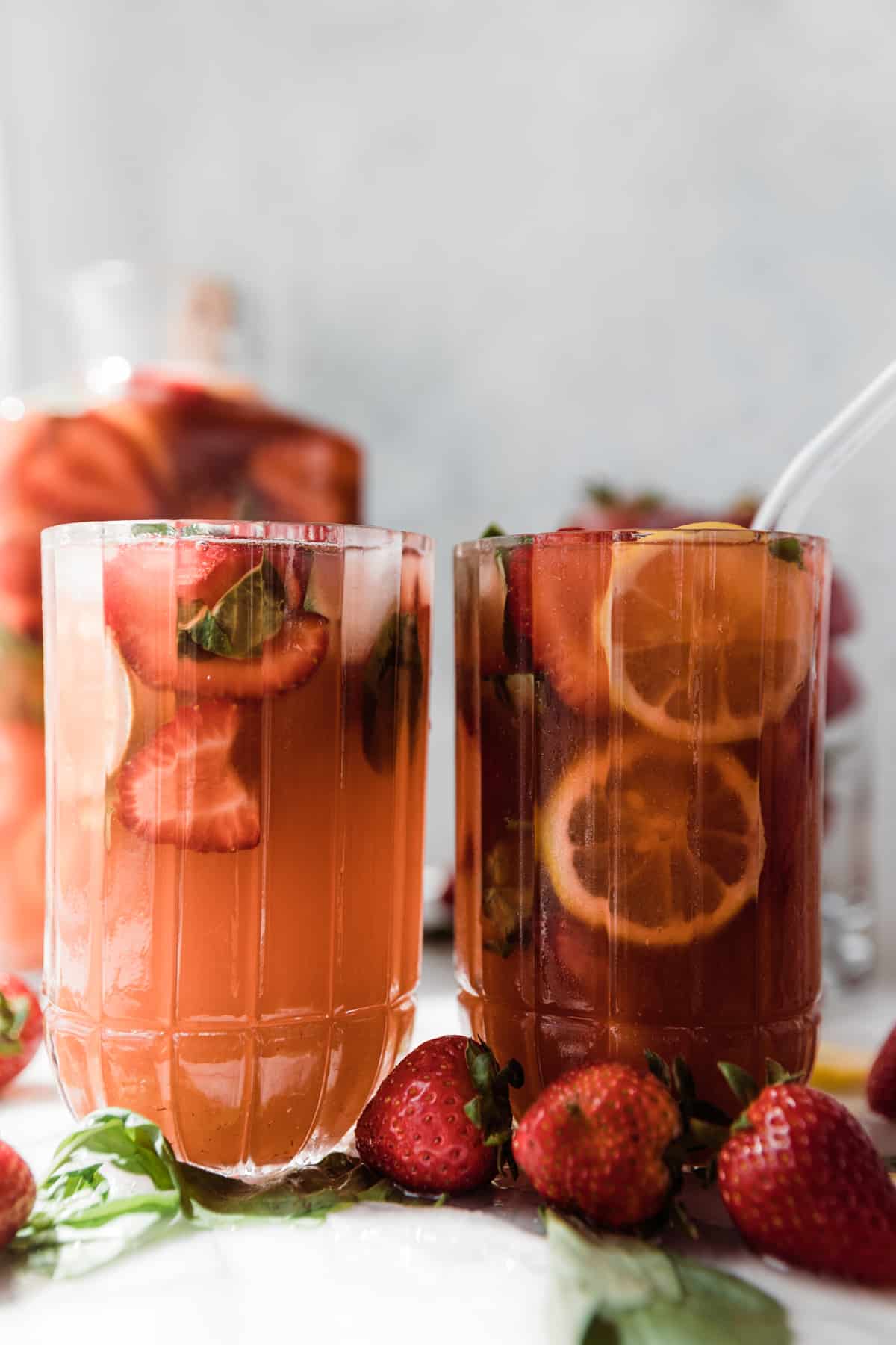 Two large refreshing glasses of strawberry basil lemonade. 