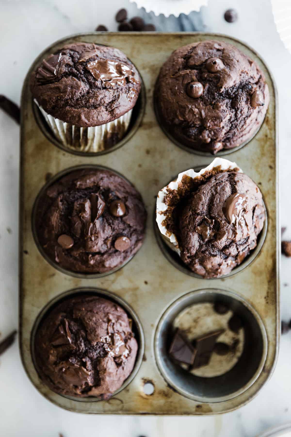 Six large chocolate chip chocolate muffins in a tin for six muffins. 