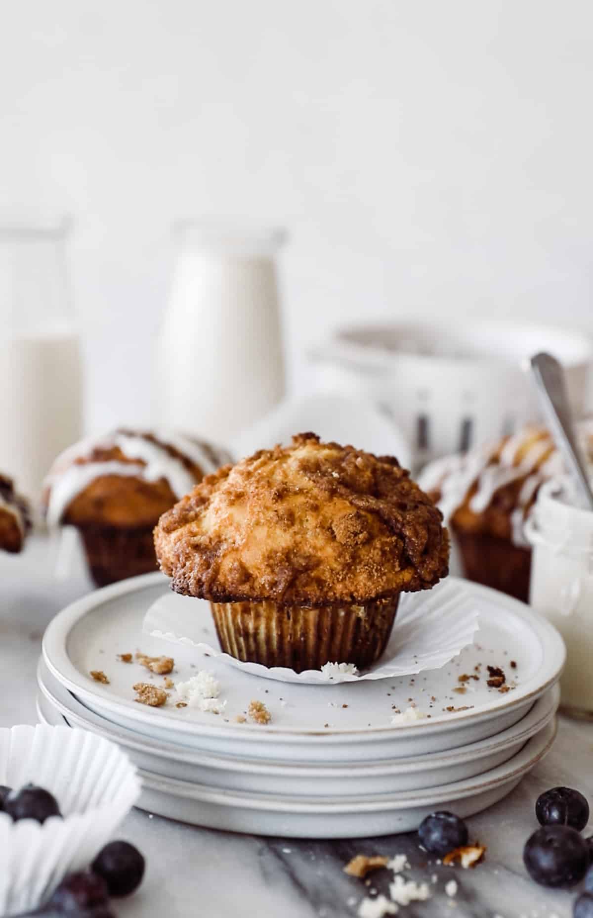 Coffee Cake muffin on three plates with crumb topping. 