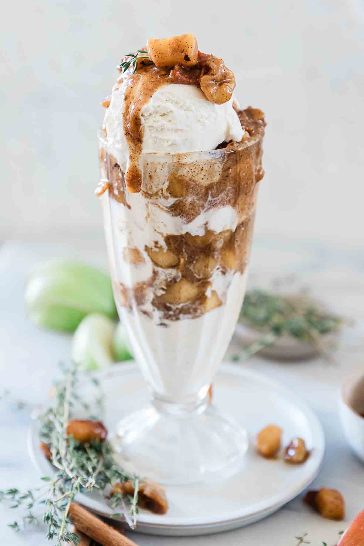 Ice cream in a sundae glass topped with cinnamon apples recipe.