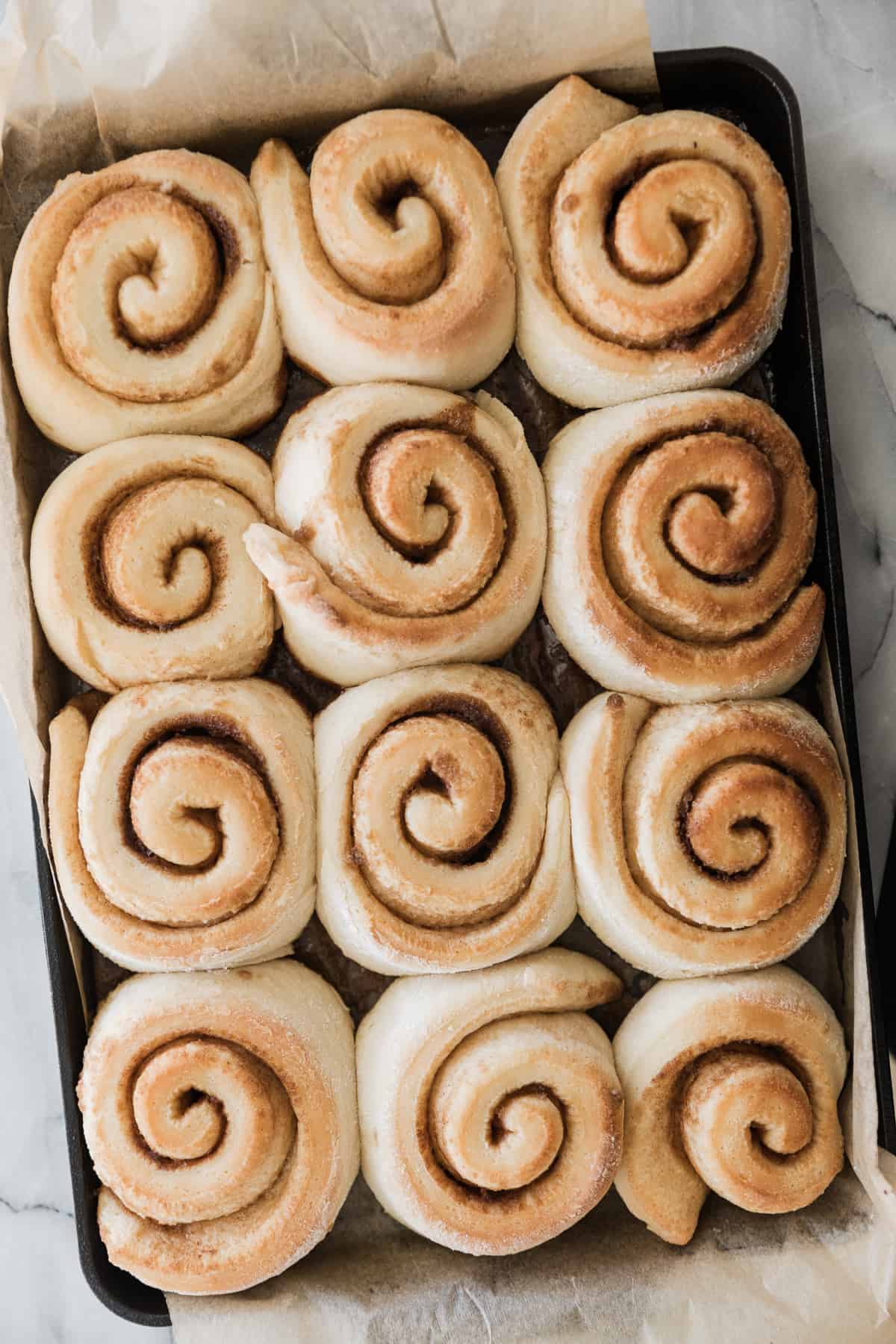 Freshly baked cinnamon rolls in their pan. 