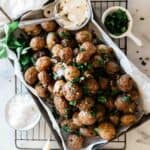 Air fryer red potatoes in a rectangle baking tray. They are garnished with parsley.