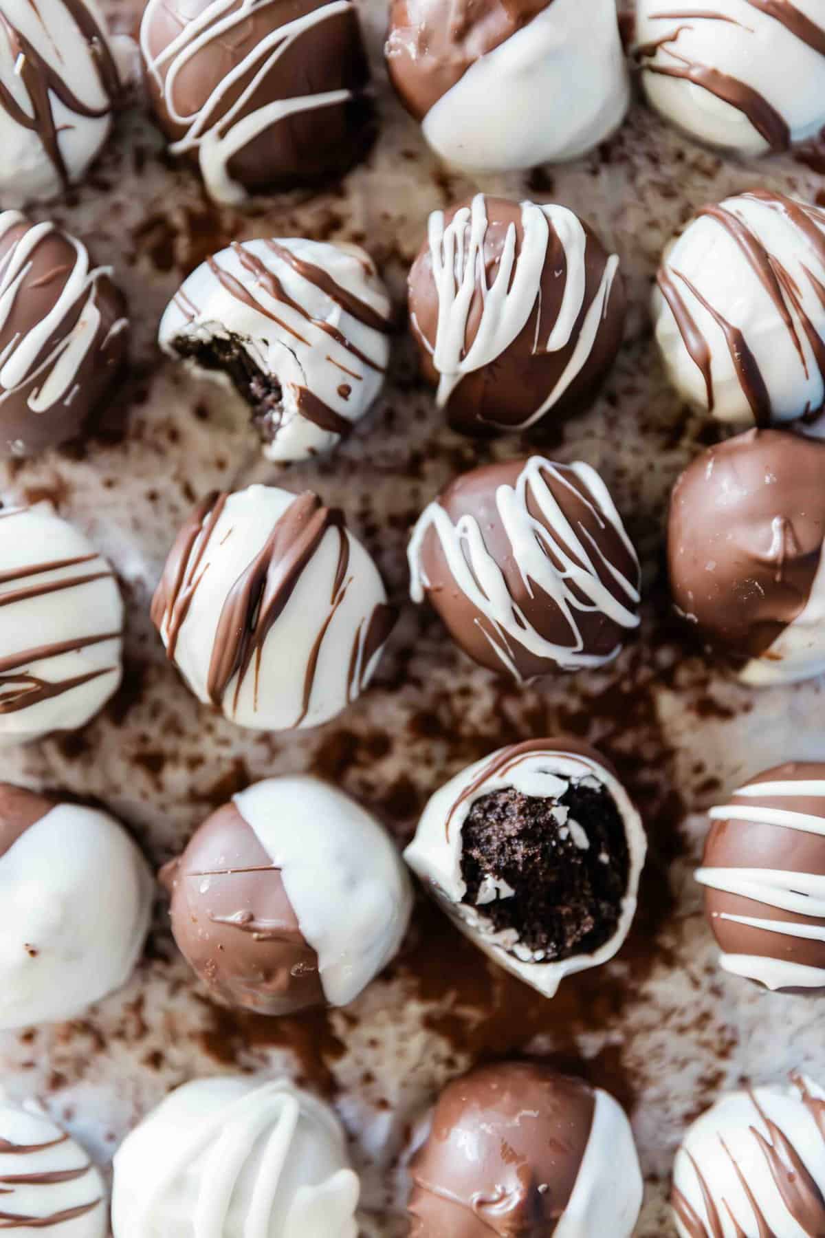 Oreo truffles recipe on a piece of parchment. There is cocoa powder scattered beneath.