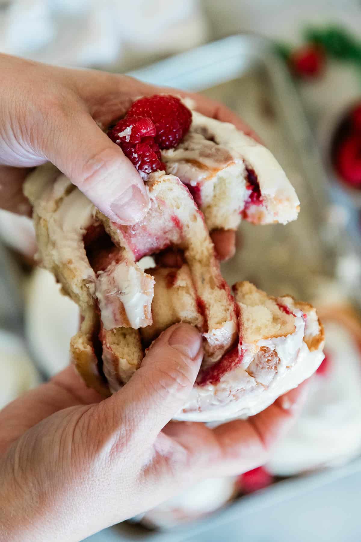 A raspberry roll being pulled apart.
