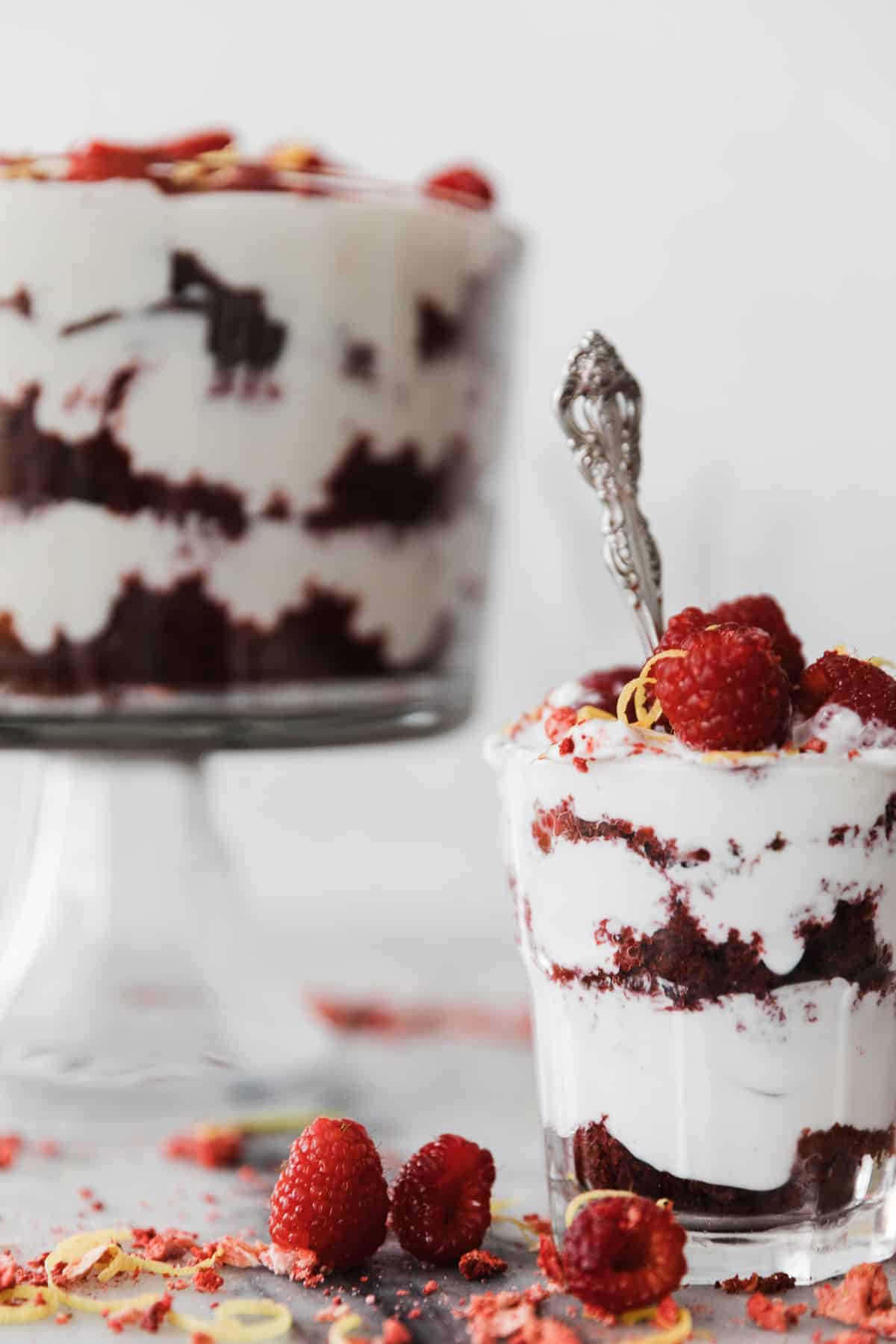 One cup of red velvet trifle and one large bowl in the background. 