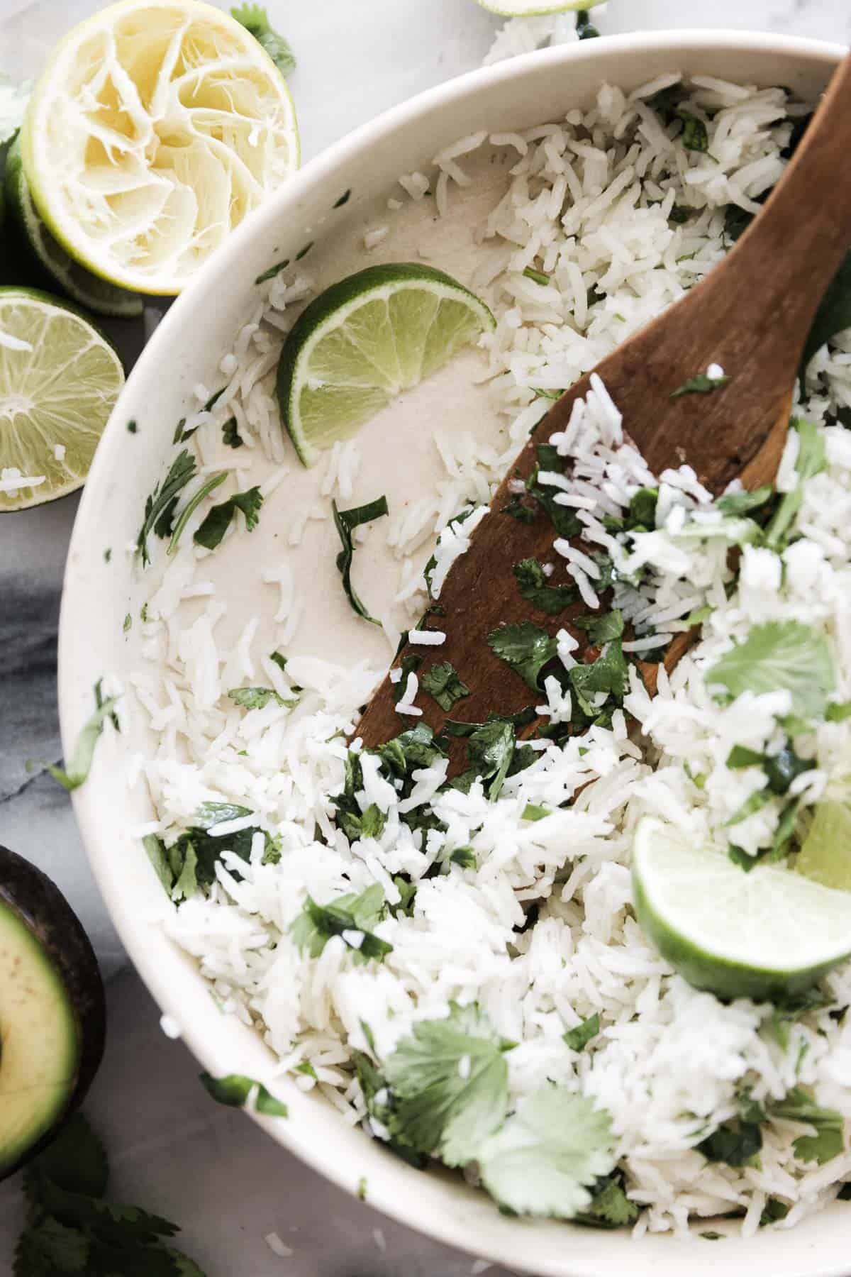 A bowl of cilantro lime rice with spoonfuls removed.