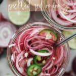 Top down photos of a jar filled with sliced red onions vinegar, spices and sliced jalapeños.