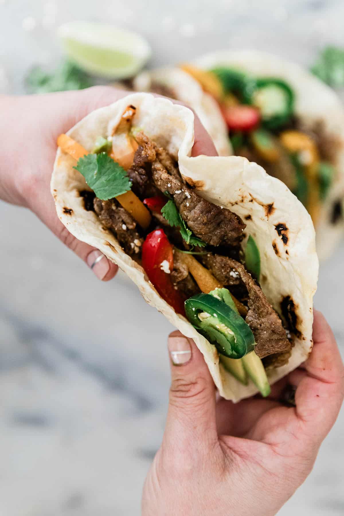 A taco made with fajita mix being held.