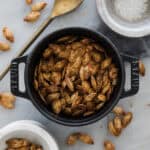 A dish of roasted pumpkin seeds on the table.