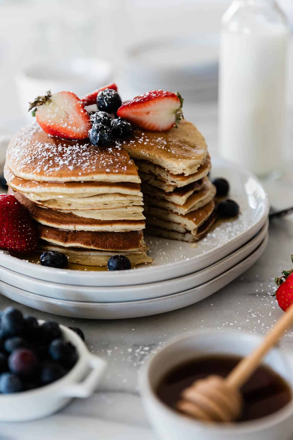 A stack of protein powder pancakes with a bite missing.