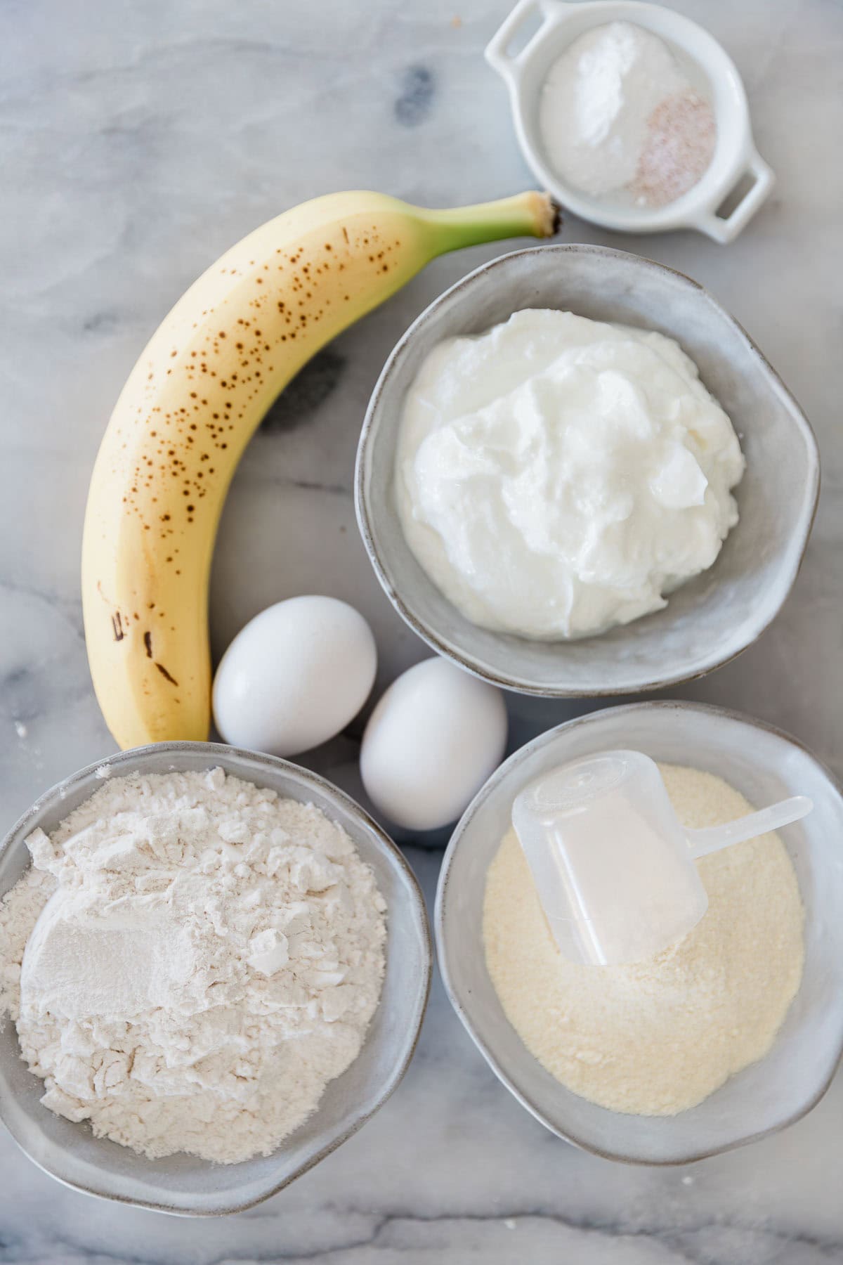 Ingredients to make healthy protein pancakes on the table before mixing up.