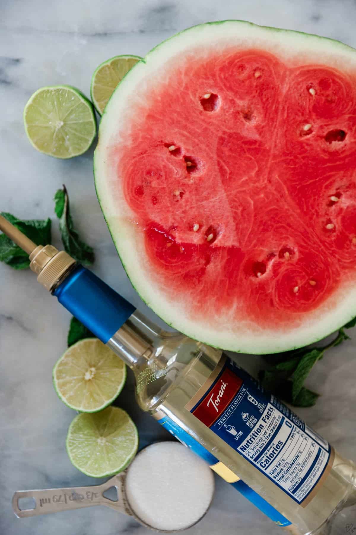 Ingredients to make a watermelon slushie on the table.