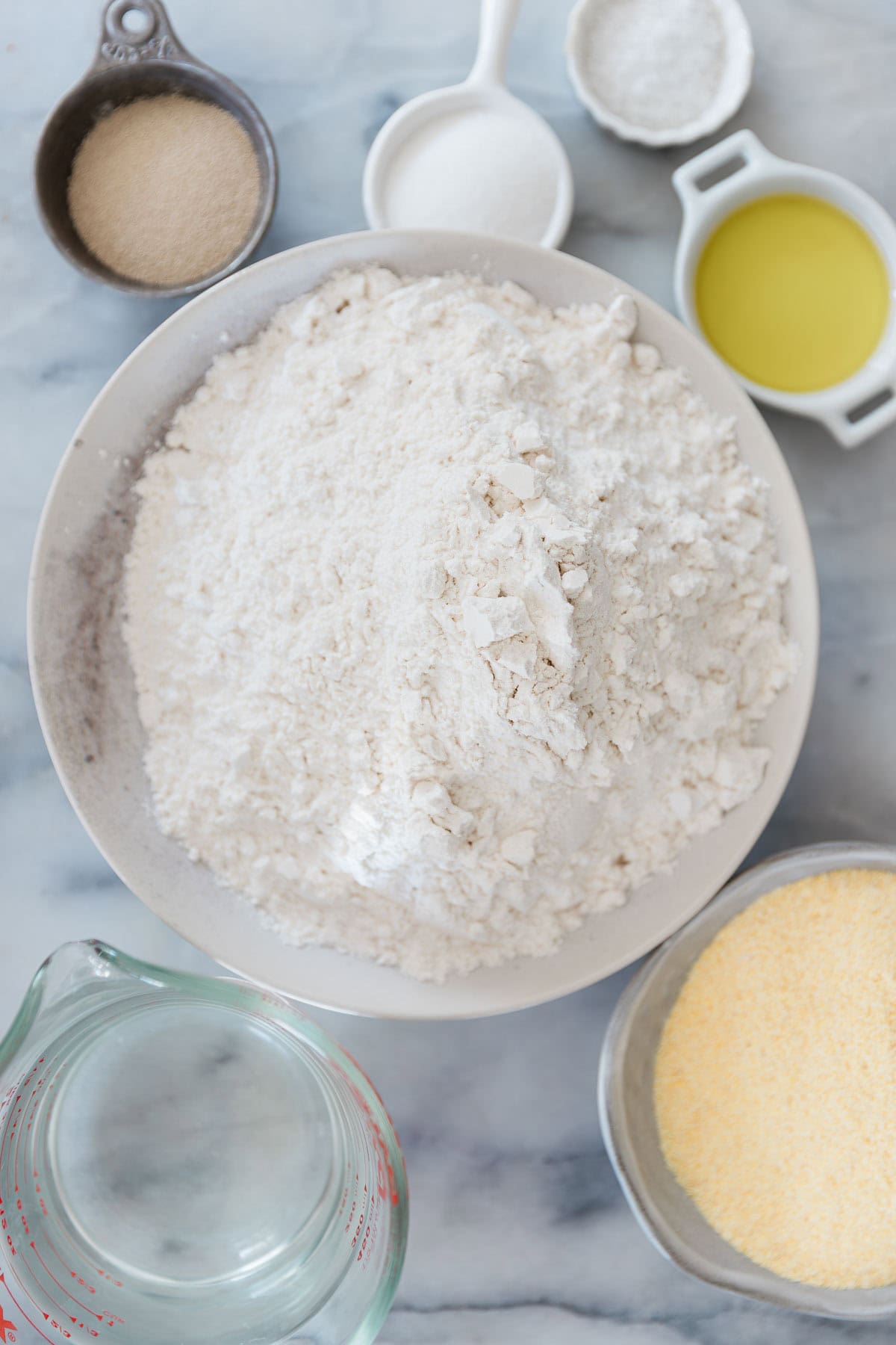 Ingredients for making homemade bread bowls in bowls.