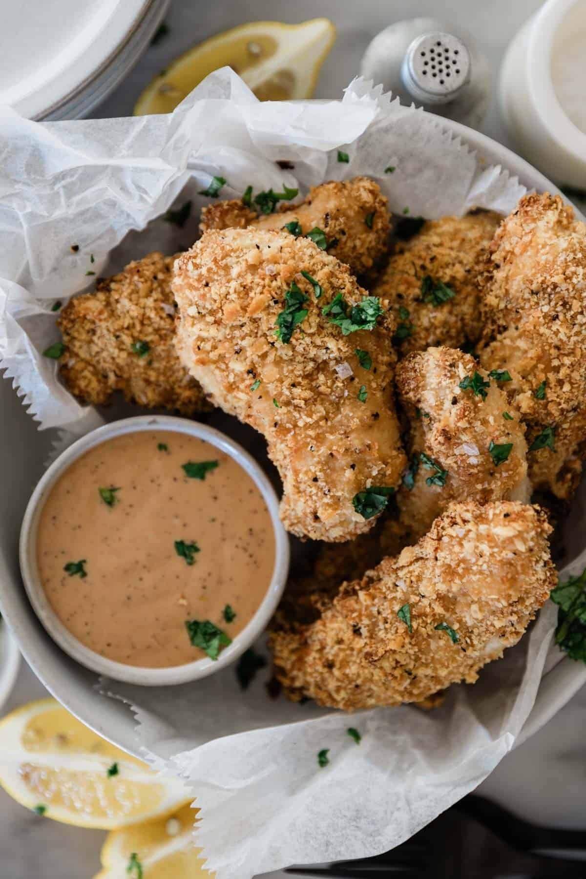 Ritz cracker chicken on a plate with dip.