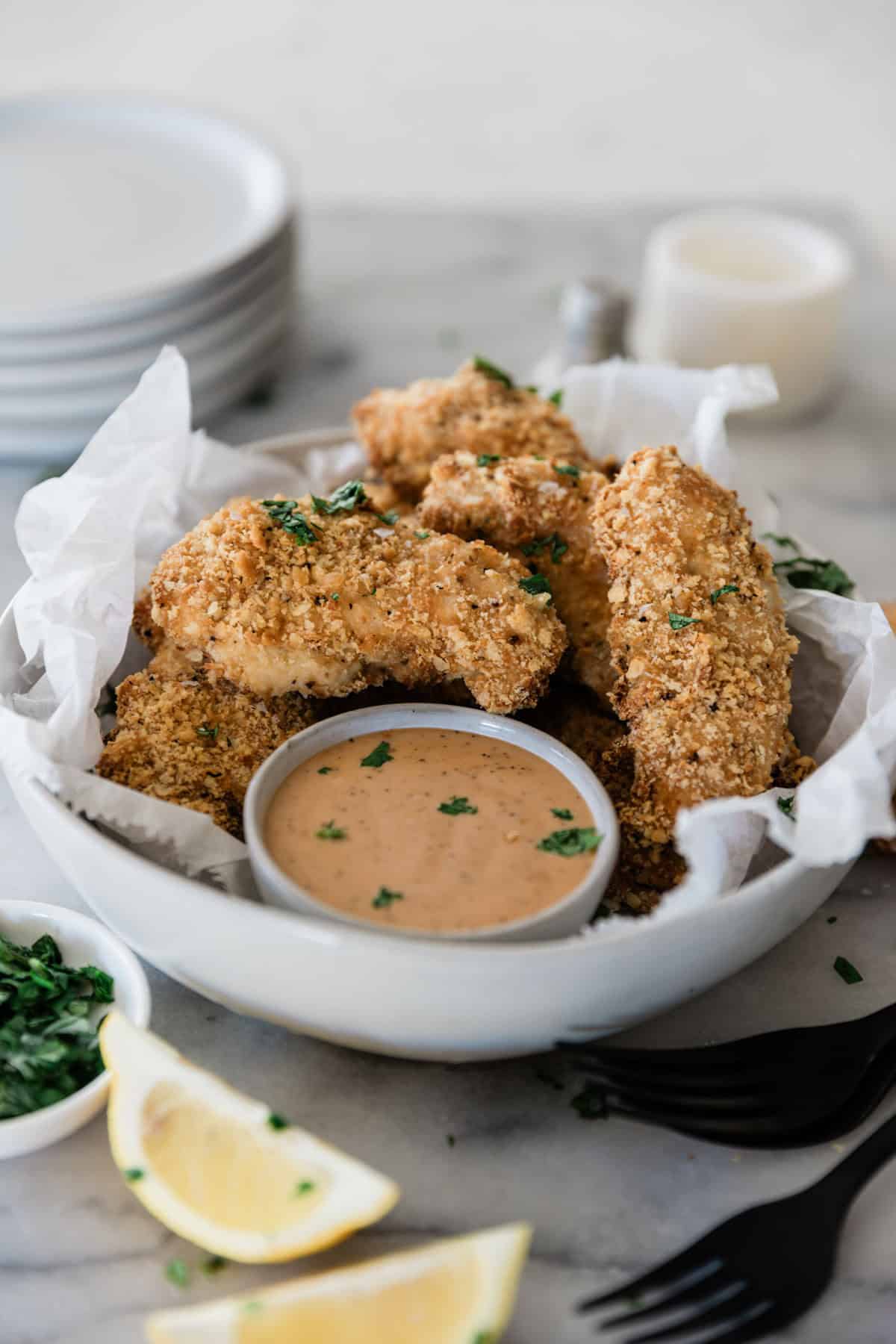 Ritz cracker chicken on a plate with dip.