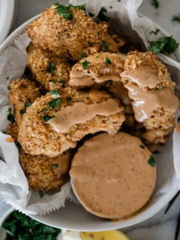 Ritz cracker chicken on a plate with dip.