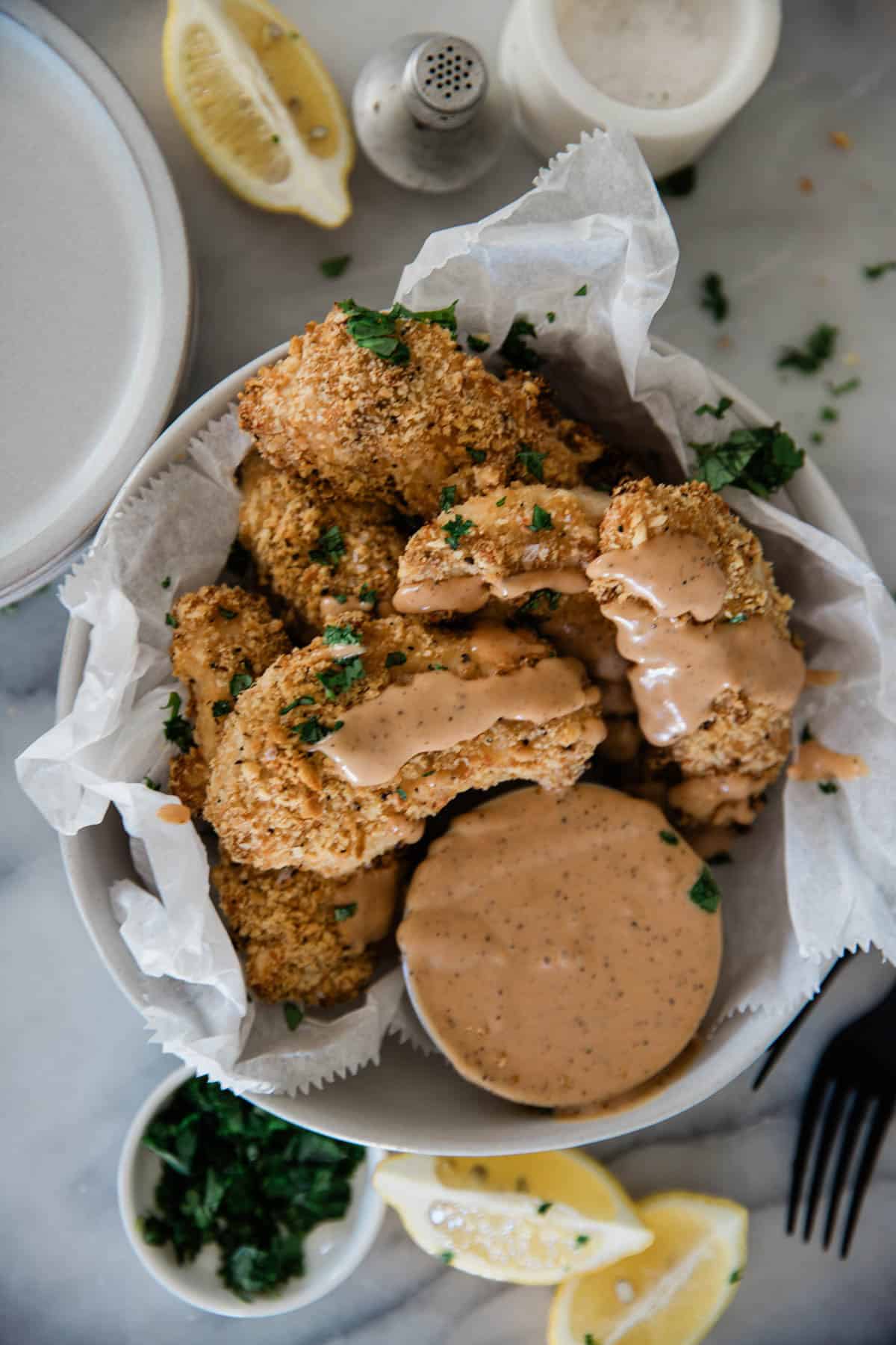 Ritz cracker chicken on a plate with dip.