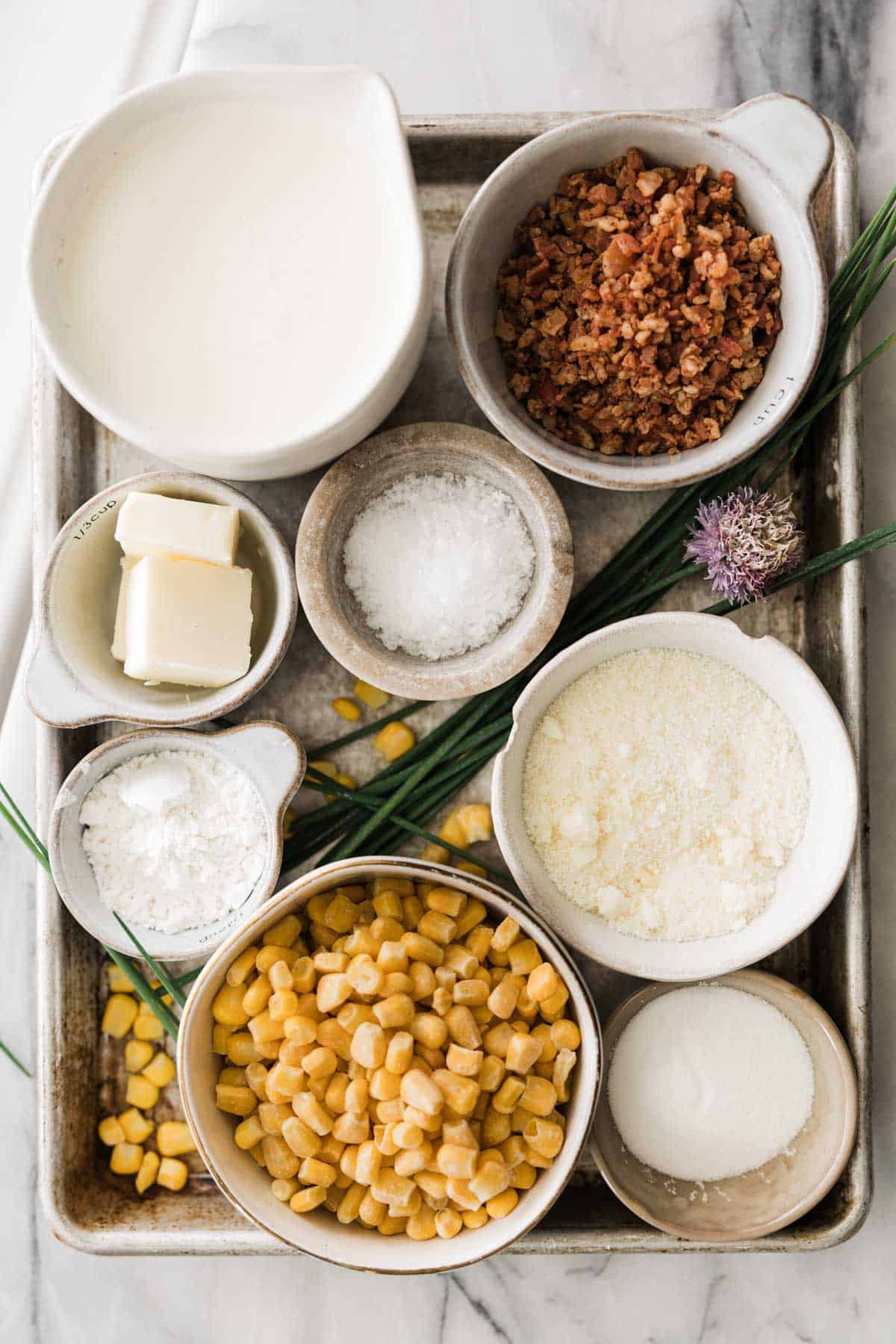 Ingredients for making homemade creamed corn in bowls.