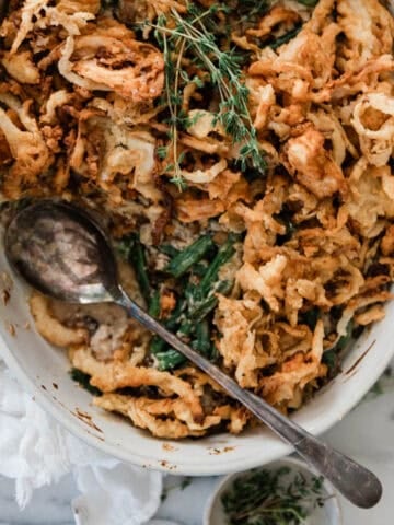 Fresh green bean casserole in an oval serving dish.