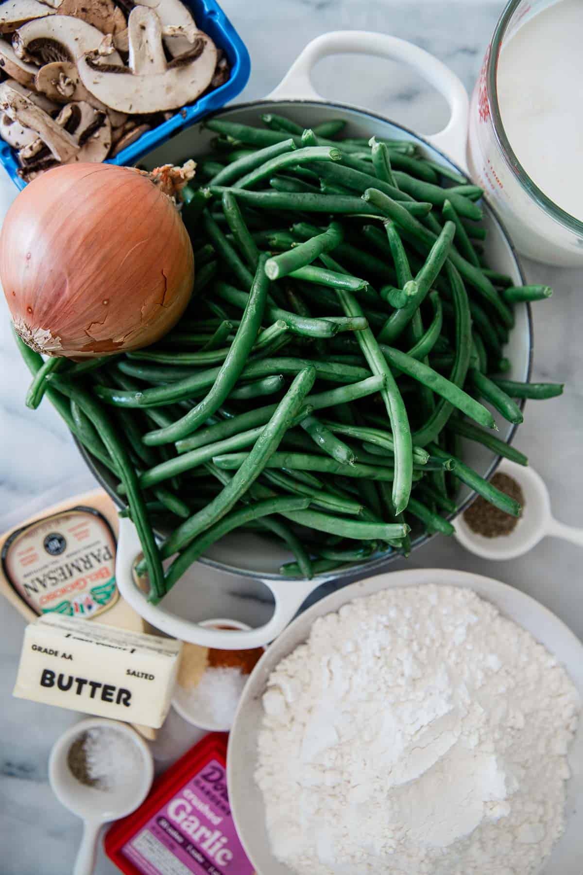 Ingredients for making fresh green bean casserole on a counter.