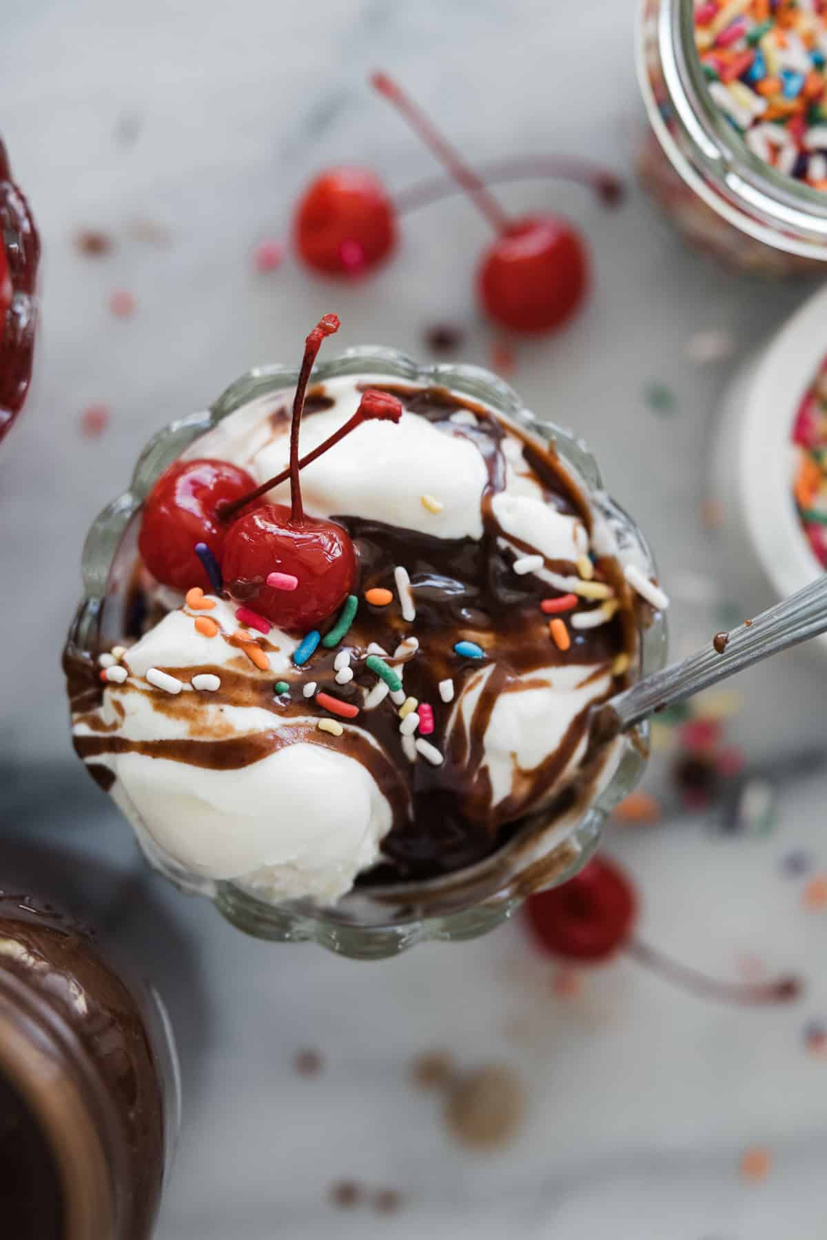 A hot fudge recipe on top of an ice cream sundae.