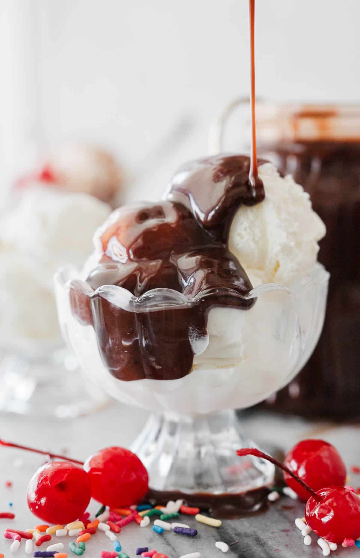 Drizzling homemade hot fudge sauce over a dish of ice cream.