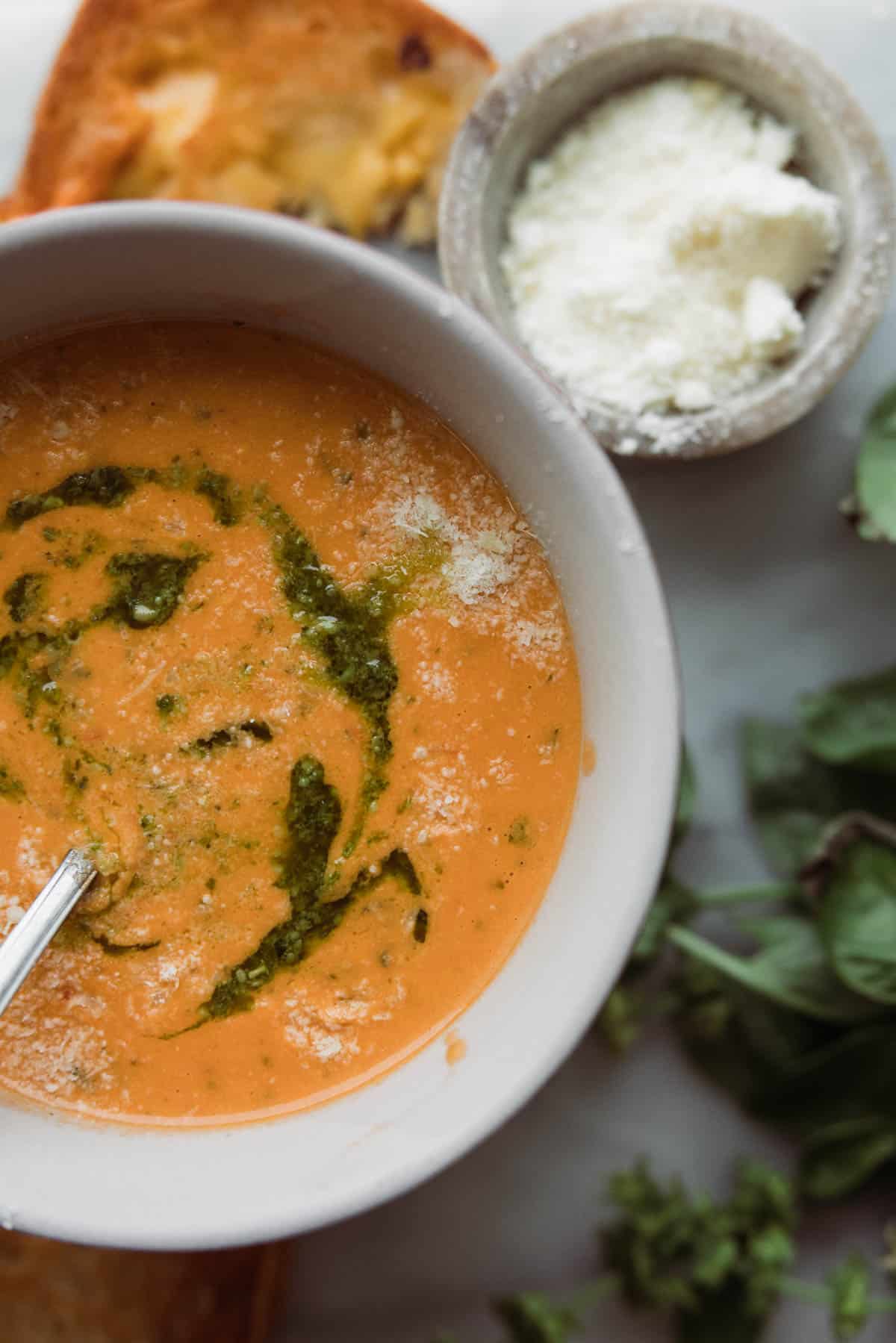 creamy tomato basil soup in bowl.