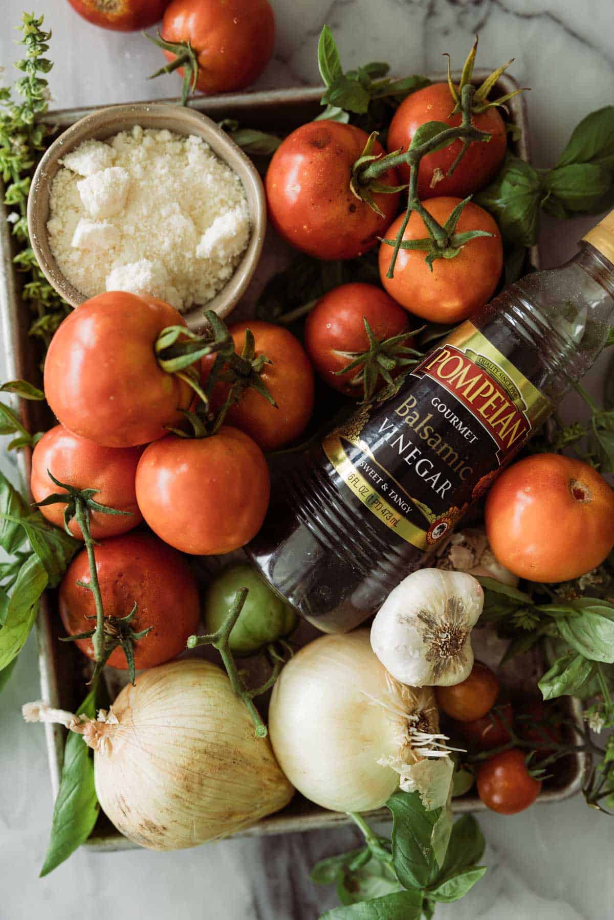 Tomatoes, parm cheese, balsamic vinegar and other ingredients for tomato basil soup.
