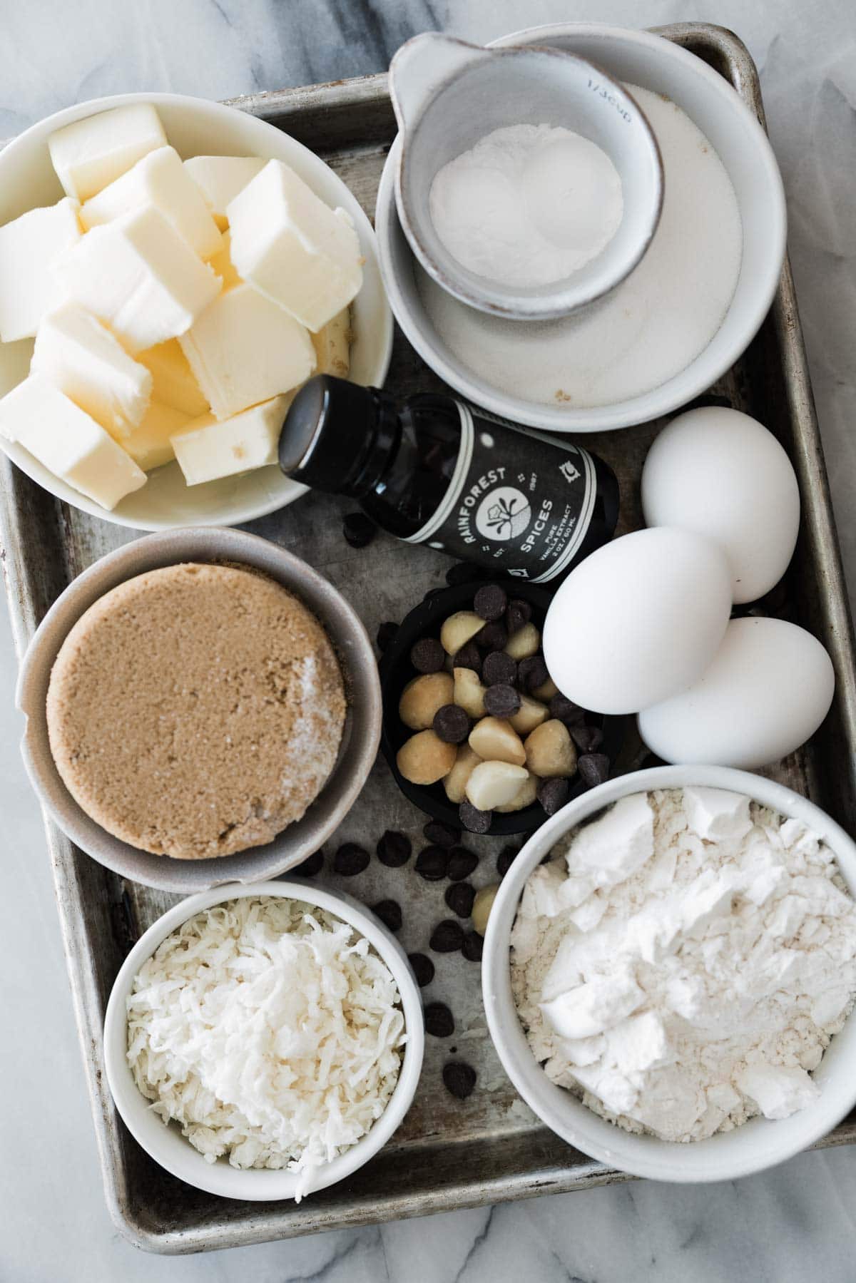 Ingredients for making coconut chocolate chip cookies in bowls.