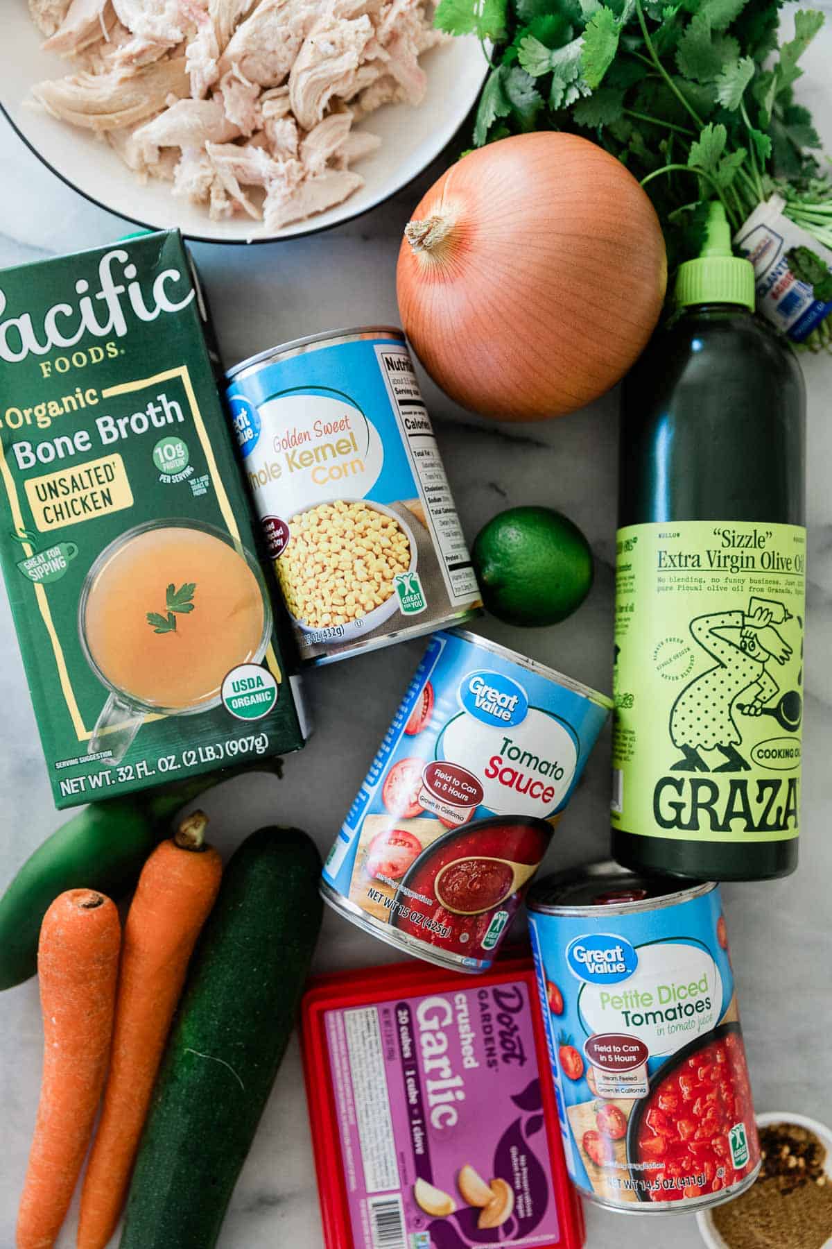 Ingredients to make this chicken tortilla soup on a table.