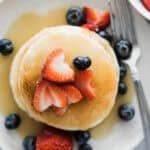 Coconut syrup over top of a stack of pancakes.