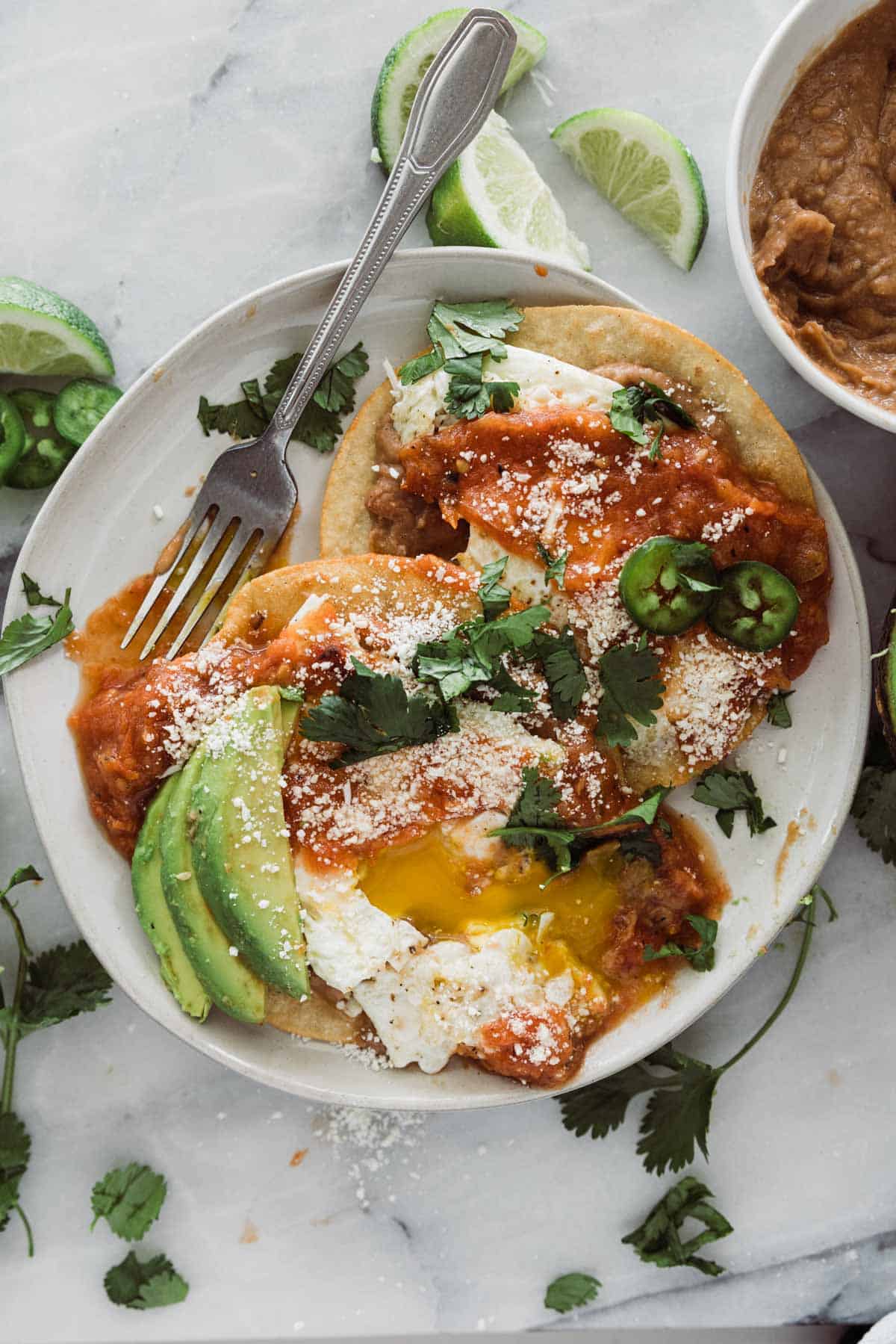 Huevos rancheros with a side of avocado.