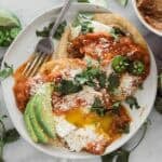 Easy huevos rancheros served on a white plate.
