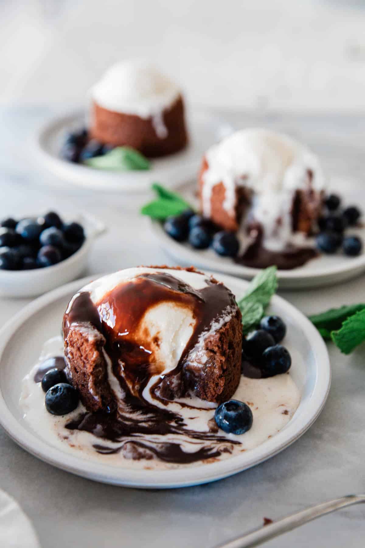 A chocolate lava cake with the filling oozing out.