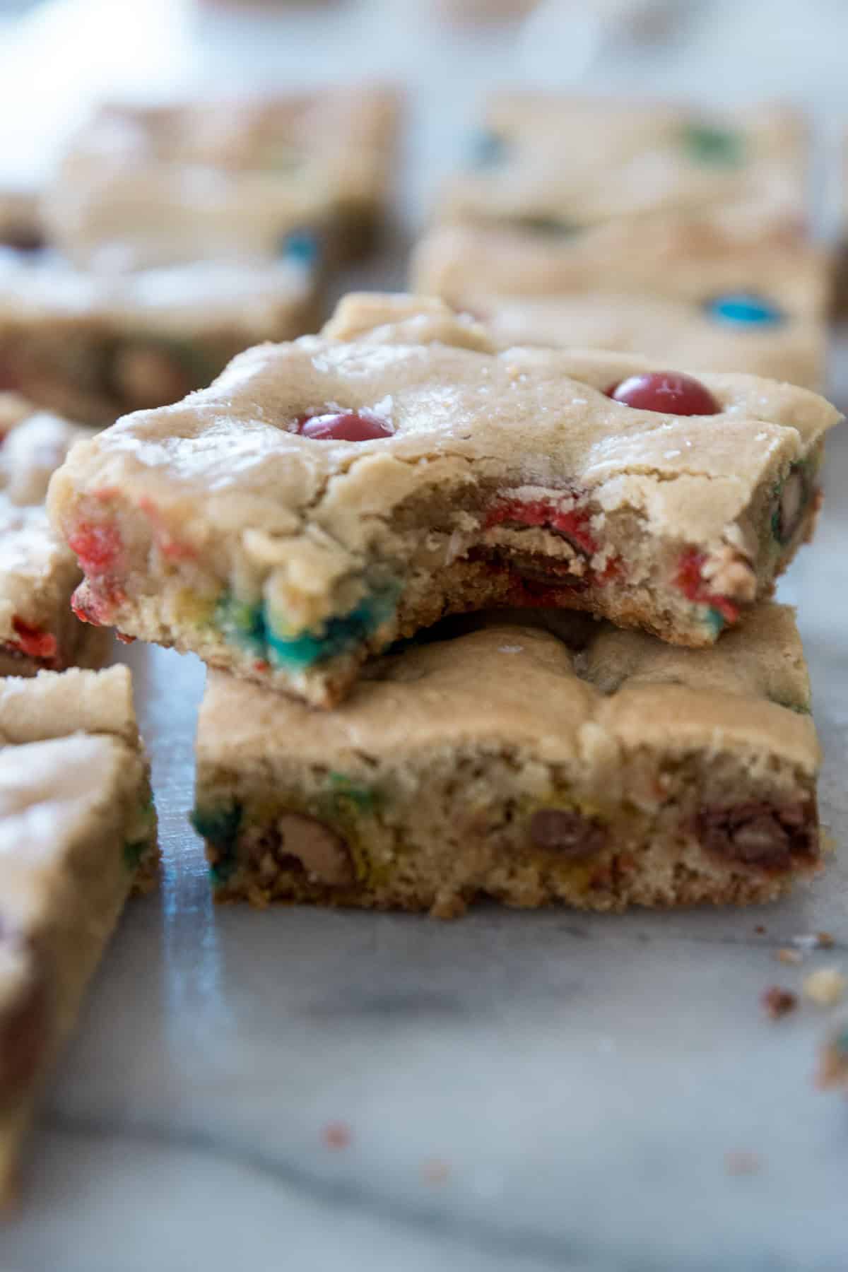 Blondies recipe stacked on another with a bite missing. 